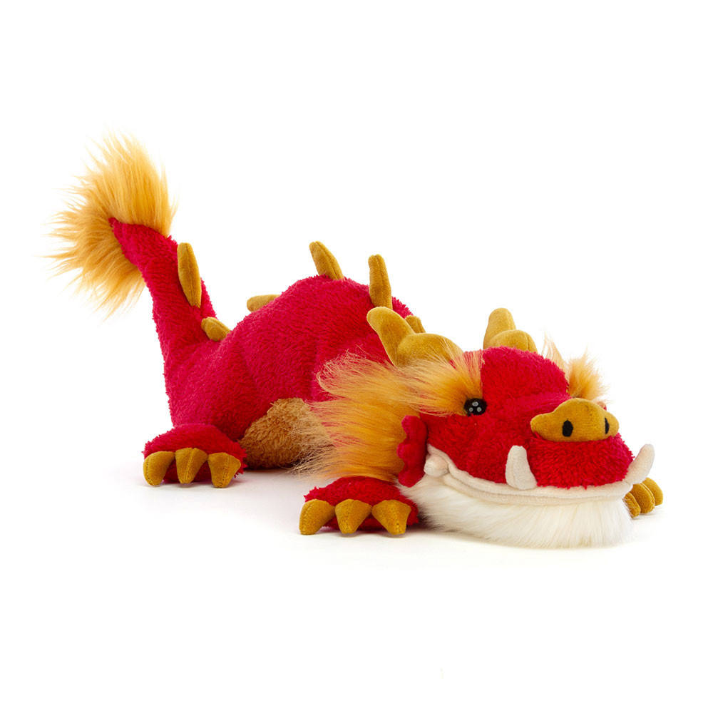 A soft long red Chinese dragon plush toy with yellow mane and white whiskers lounging on a white background.