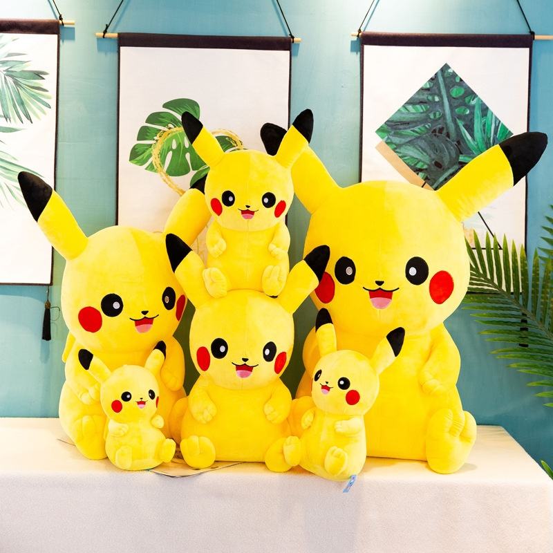 A group of yellow Pikachu plush toys in various sizes from mini to extra large, arranged in a nursery room.