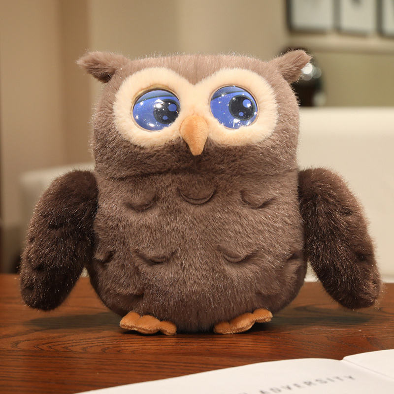 Close-up detail of a grey owl plush with bright glowing blue LED eyes and soft fur.